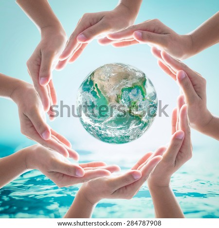 Green planet among collaborative human hands on turquoise blue water background : World ocean and nature environment concept: Healthy oceans, healthy planet : Elements of this image furnished by NASA