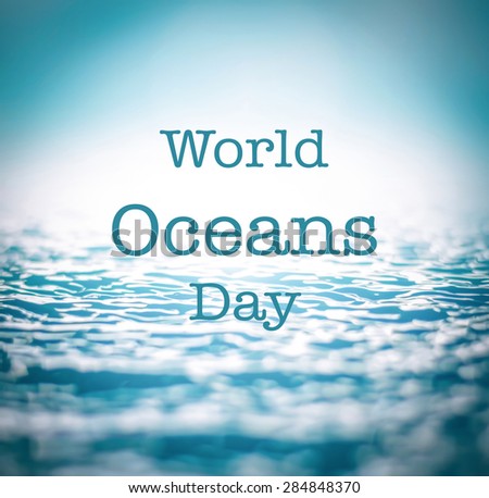 World oceans day texts on blurred nature background of wavy water in turquoise color tone
