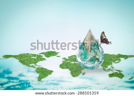 Butterfly drinking water from green globe water drop with world map and blue ocean background: World environment concept to combat desertification and drought :Elements of this image furnished by NASA