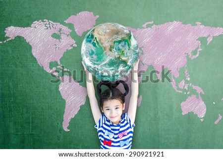 Happy Asian girl kid child raising hands holding green globe on green chalkboard with pink hand drawn world map background: World literacy concept : Elements of this image furnished by NASA