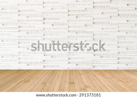 Modern marble tile wall pattern background in light white beige color with wooden floor in yellow brown tone : Horizontal marble rock stone tiled pattern texture backdrop with wood flooring