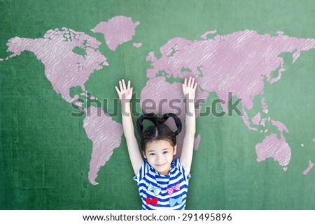 Happy Asian girl kid raises hand up in front of green chalkboard: Little student raising hands over pink chalk freehand drawing of world map blackboard background: International children\'s day concept