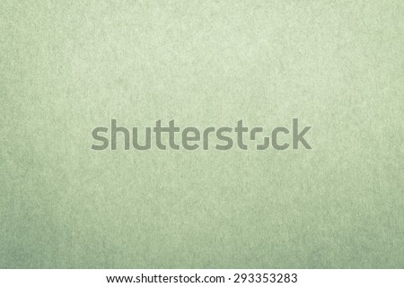 Recycled craft paper textured background in light green leaf color tone: Detailed texture of recycled paper fiber