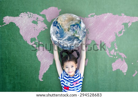 Happy Asian girl kid holding globe over green chalkboard with pink world map background: Little child raising hands carrying planet in front of blackboard: Elements of this image furnished by NASA