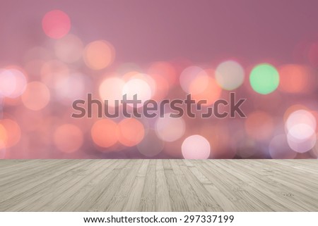 Wooden floor in light red brown color tone with blurred abstract background of night city view with candle lights bokeh in warm vintage color tone for interiors