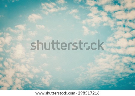 Vintage style paper texture with blurred nature background of blue sky and soft scattered clouds with heart shaped empty space in the air in the middle: Water colour  textured paper with retro sky