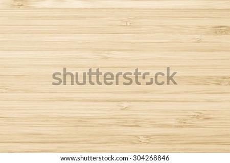Wooden textured grainy detail backdrop in light yellow cream color tone: Bamboo wood laminated board detailed texture pattern background in yellow creme beige brown toned colour