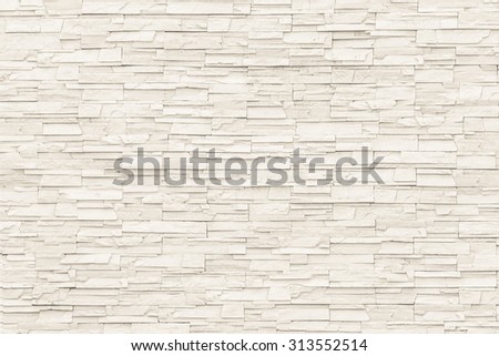 Rock stone brick tile wall aged texture detailed pattern background in cream beige brown color tone: Grunge ancient rustic limestone patterned backdrop for decoration in creme brown toned colour