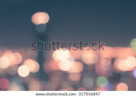 Vintage style blurred abstract background holiday nightlife colorful bokeh in cool cyan turquoise blue color tone: Blurry rooftop view beach front night lights party with lighthouse