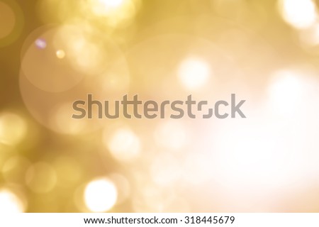 Vintage warm yellow gold color tone blurred nature background of a view looking up through the orange foliage of a tree against the sky facing sun flare and bokeh: Blurred natural greenery bokeh
