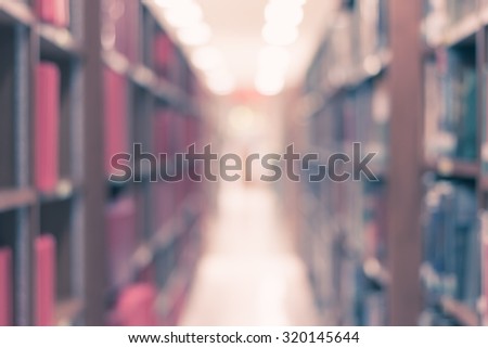 Vintage style color tone blurred abstract background of a view of an aisle of book shelves in school library: Blurry interior perspective of a study room with tables, chairs and stacks of books