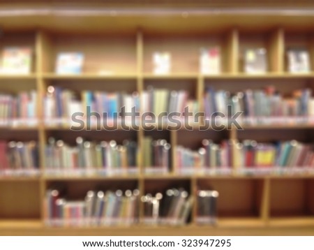 Blurred abstract background of book shelves in public library: Blurry perspective view of a study room with rows and stacks of books: Blur educational interior reading room with textbook