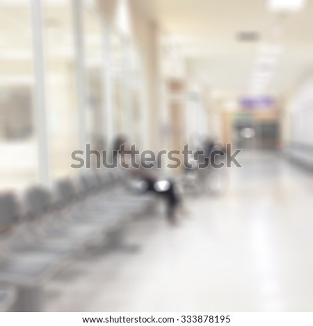 Blurred abstract background inside hospital interior in OPD outpatient's clinic department  on corridor with hallway with seat row for patients and visitors: Blurry perspective view of waiting area