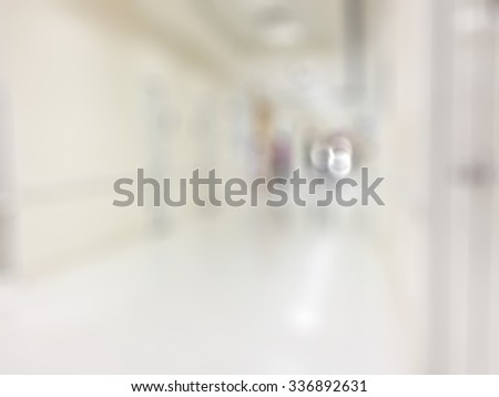 Blurred abstract background of indoor hospital interior in hallway/ corridor/ lobby waiting area for patients, nurse, doctors and clinical staff circulation in clean, bright and hygienic environment