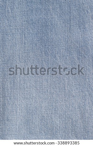 Blue jeans denim fabric textile texture background: Light pale blue color tone worn denim wear woven cloth textured detailed pattern grunge backdrop