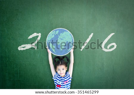Happy girl child kid raising chalk drawing world globe w/ freehand writing text message new year 2016 seasonal celebration on green grunge chalkboard background celebrating year end and holidays