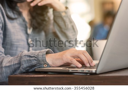 Vintage style woman working on computer device in coffee shop thinking concentrating focus work Hand typing keyboard: People lifestyle IOT wifi cyber IT communication technology daily life seo ppc im