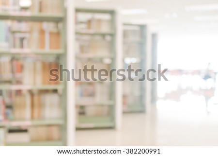 Vintage style color tone blurred abstract background of aisle of data collection shelves in school library: Blurry interior perspective view of a study room with tables, chairs and stacks of books
