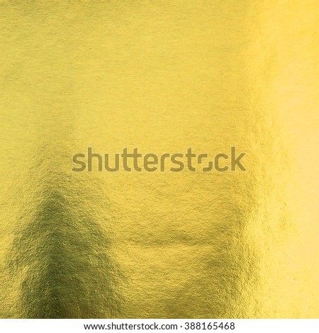 Shiny hot yellow gold foil leaf paper decorative texture background: Crumpled bright brilliant festive glossy metallic look textured backdrop: Aluminium tin metal steel material for design decoration