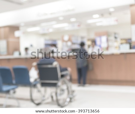 Blur abstract background perspective view of wheelchair seat row in hospital building interior/ clinical hallway indoor area w/ visitors patients waiting to see doctors, people paying money at cashier
