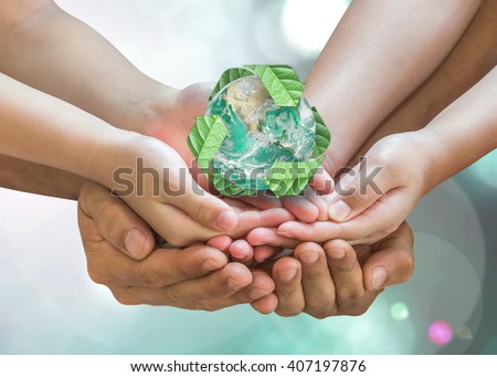 Parent and children holding together recycled green leaf sign planet on person hands on blur nature greenery background sun flare: Environment CSR ESG concept. Elements of this image furnished by NASA
