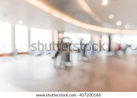 Blur abstract background modern fitness center with health exercise equipment : Blurry perspective view of gym facility service room: Empty gymnasium indoor space for diet, bodybuilding and training