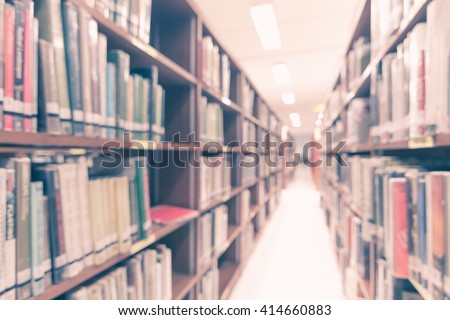 Vintage style blurred abstract background view of university student girl behind aisle of book shelves in school library: Blurry interior perspective indoor study room, table chair seat, book stack