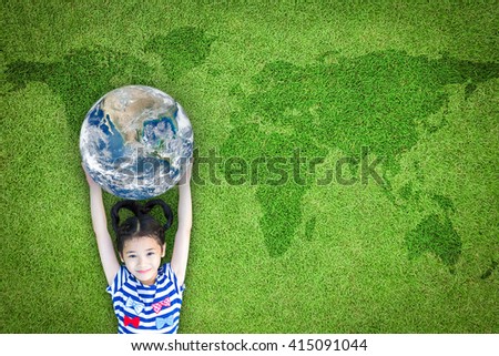 Happy young girl child kid raising blue marble planet earth grass ground lawn nature background: World sustainable environment CSR ESG eco bio friendly concept: Element of the image furnished by NASA