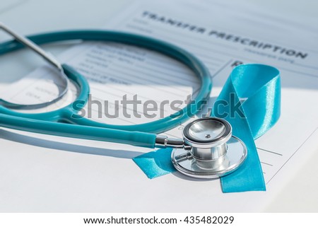 Light blue color ribbon awareness symbolic logo concept for prostate cancer awareness on  patients health record prescription paper note form with doctor stethoscope on physician\'s working table/ desk