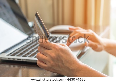 Human woman hand holding credit card using pc computer 4G wifi internet IT IOT online IM market shopping advertising: Adult buyer person typing credit card number order goods/ booking from home office