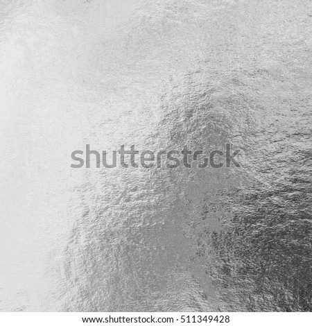 Shiny silver white grey gray paper foil decorative texture background: Bright brilliant festive glossy metallic look textured backdrop:  Metal steel like material pattern surface for design decoration