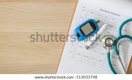 Blood drop examination stripe tool kit on patient\'s glucose sugar level testing record paper document: World diabetes day: National American diabetic awareness month: Hospital  healthcare concept
