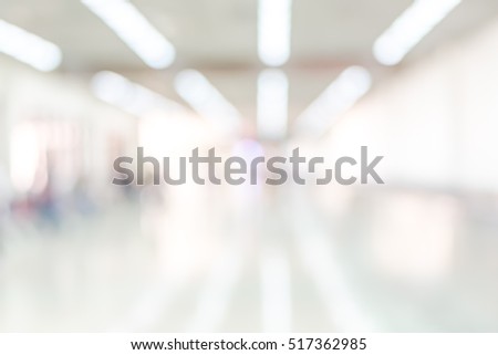 Blur abstract background airport corridor walkway passage access entrance to terminal gate: Blurry perspective view bright white light illumination pave floor and wall architecture building interior