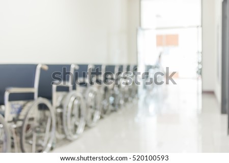 Blur medical abstract background hospital walk way corridor with patient\'s wheelchair for disabled person/ people: Blurry perspective view wheel chair seat row in clean clinical interior indoor space