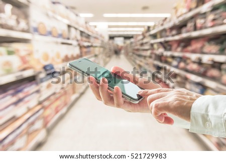 Business person hand using cellphone (clipping path) blur abstract background supermarket: Woman user typing mobile phone touchscreen shopping: Home telecommunication ordering buying purchase payment