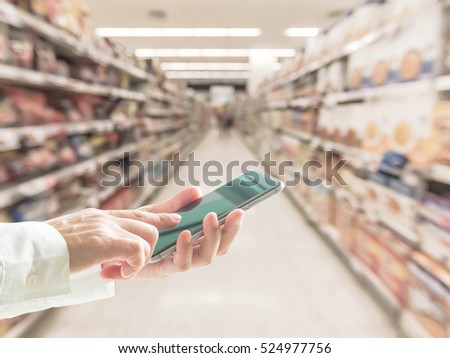 Business person hand using cellphone (clipping path) blur abstract background supermarket: Woman user typing mobile phone touchscreen shopping: Home telecommunication ordering buying purchase payment