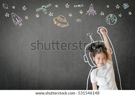 Happy little asian girl kid in astronaut suit doodle drawing, universe space out of earth planet on school black class chalkboard chalk board background Creative innovation educational conceptual idea