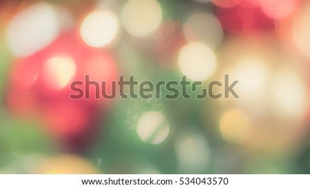 Blur abstract background merry christmas party celebration xmas tree night light bokeh party warm green red yellow orange white sweet tone: Blurry view happy holiday enjoy joy world nightlife concept