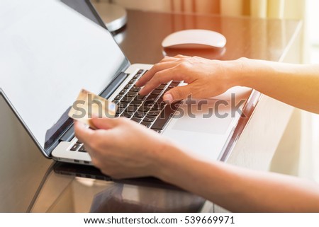 Human woman hand holding credit card using pc computer wifi internet online iot omni-channel market shopping advertising: Adult buyer typing keyboard order goods paying payment from anywhere workplace