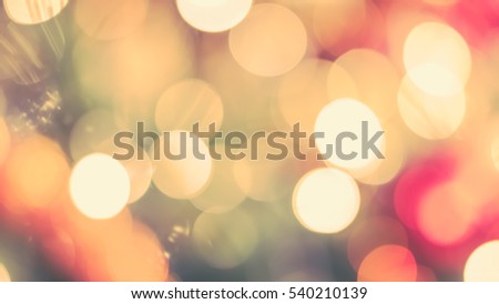 Blur abstract background christmas xmas tree party night light bokeh celebration in warm vintage gold green red yellow orange white tone: Blurry view holiday happiness joy world nightlife concept