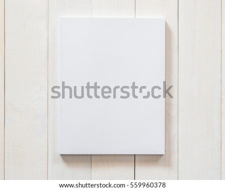 Blank white book cover template mockup with front page side placing on clean cream surface pine wood background: Empty paperback magazine catalog note book paper texture mock up on wood table backdrop