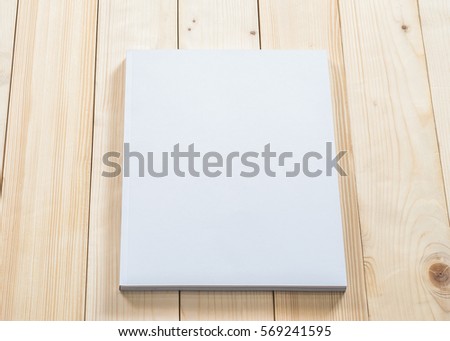 Blank A4 size book cover template with page in front side lay flat on natural white cream surface wood background: Empty paperback magazine catalog note book paper texture mockup on table backdrop