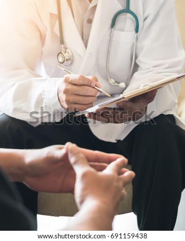 Doctor consulting male patient, working on diagnostic examination on men\'s health disease or mental illness, while writing on prescription record information document in clinic or hospital office