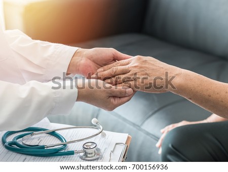 Geriatric doctor (geriatrician) consulting and diagnostic examining elderly senior adult patient (older person) on aging and mental health care in medical clinic office or hospital examination room