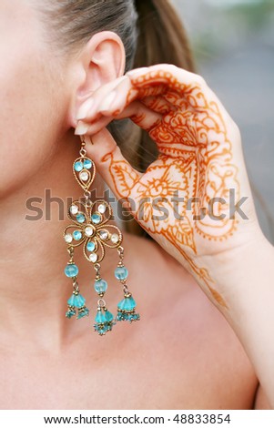  earrings and tattoo on the palm