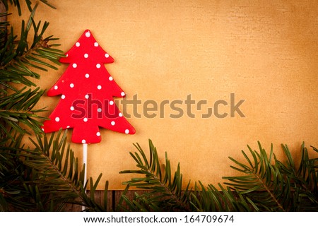 Polka dots Christmas tree decoration on old paper background.