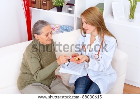 Nurse gives the senior woman her medicines