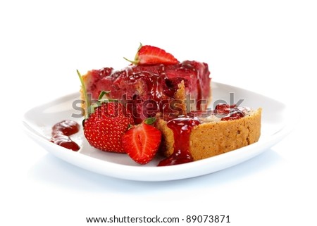Strawberry cake with jam and fruits on a plate, white background