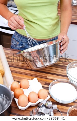 Hands of a woman making cake in the kitchen