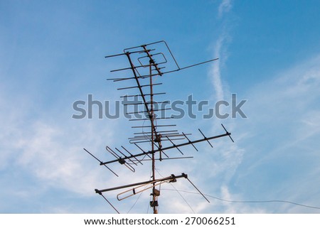 Old TV antenna and blue sky white cloud background